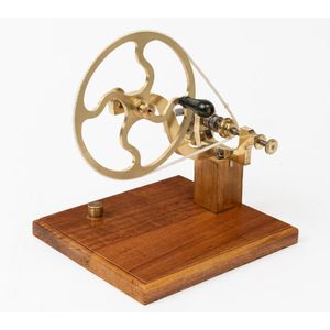 A brass watchmaker's lathe, the large crank wheel with an ebony…