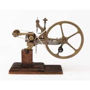 A brass watchmaker's topping tool, 19th century, with a wooden…