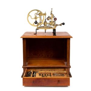 A watchmaker's gear cutting engine with a full set of cutters,…