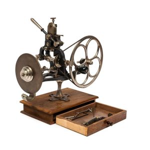 A brass watchmaker's topping tool with a partial set of cutters,…