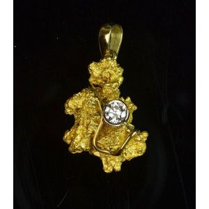 A natural gold nugget, having an 18ct bale and bezel set…