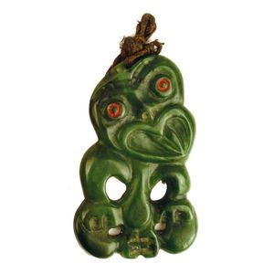 A pounamu hei tiki, modelled with head tilted and chin to left…