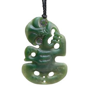 A Maori greenstone tiki, New Zealand, paua shell rings around…