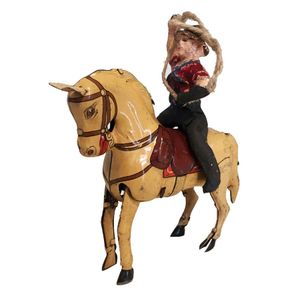A collection of tin toys, including a Kohler wind-up cowboy…