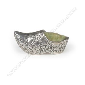 A miniature silver pin cushion, in the shape of a Dutch clog,…