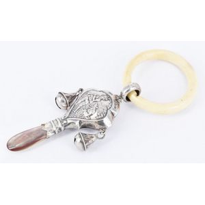 A sterling silver baby rattle, ivory ring, mother of pearl…