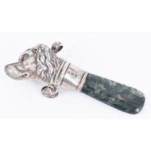 A baby rattle, moss agate handle, sterling silver head shaped…