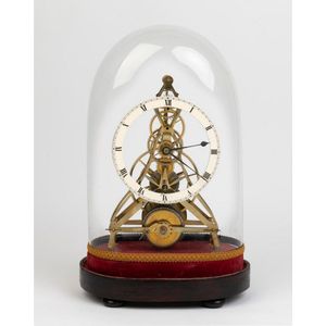 A small English brass skeleton clock with balance wheel, circa