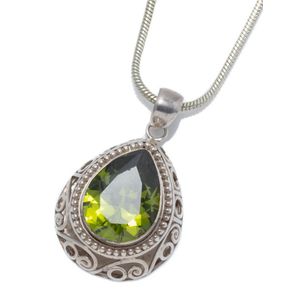 A silver stone set pendant necklace; set with a 20 x 16 mm pear…