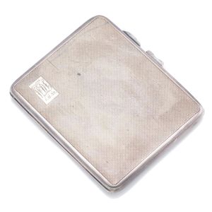 A hallmarked silver card case, engine turned design with small…