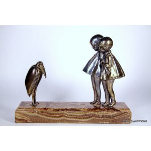 A cold painted figural group of two girls and a bird by Demetre…