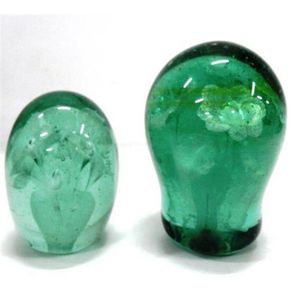 Two 19th century green glass dump paperweights, foil flowers in…