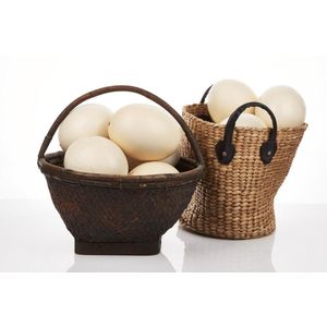 Collection of ostrich eggs, within two woven baskets (17).…