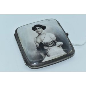 A sterling silver cigarette case with gilt interior and…