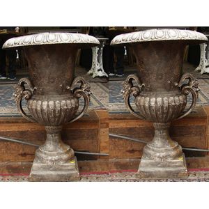 A pair of Victorian style twin handled garden urns having faun…