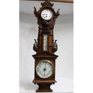 An outstanding English honey oak barometer with clock adorned…