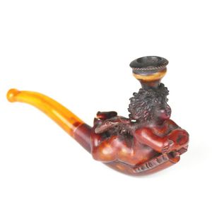An old Meerschaum and amber pipe, in the form of a winged cupid…