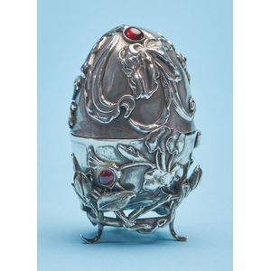 A Russian silver egg on stand, of ovoid form, with embossed…