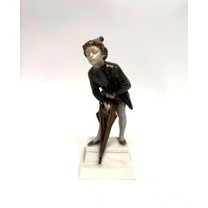 A Royal Copenhagen porcelain figure of a boy with his umbrella,&hellip;