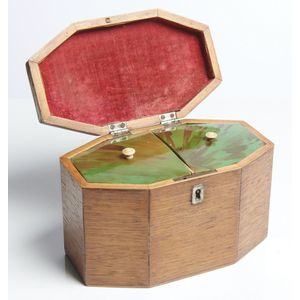 A George III oak tea caddy, early 19th century, octagonal in…