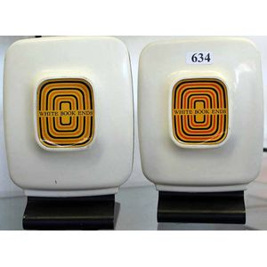 A pair of mid century modern book ends, plastic on metal base.…