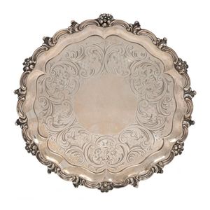 An antique English sterling silver salver with engraved…