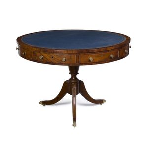 A mahogany drum table with tooled blue leather inset and an…