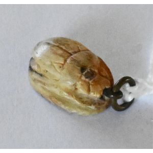 A scarab beetle pendant, cream glaze, length 1.5 cm