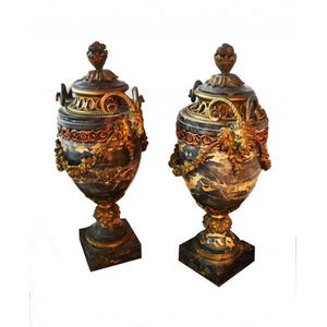 A pair of French marble urns with decorative metal mounts,…
