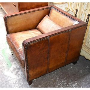 An Art Deco style hardwood and leather club armchair the square…