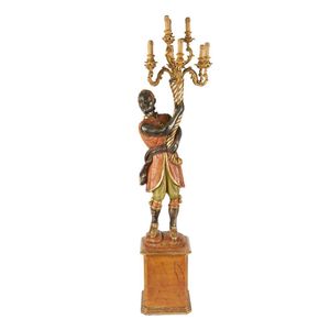 An Italian polychrome blackamoor lamp, circa 1940, carved, in…