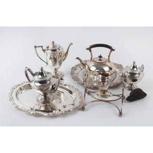 An antique silver plated spirit kettle, four piece tea service…