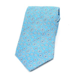 A silk tie by Hermes, styled with a circular design on a blue&hellip;