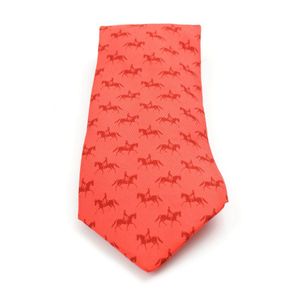 A silk tie by Hermes, styled in red with an equestrian pattern