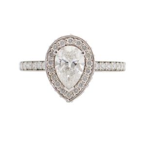 A diamond ring, featuring a pear cut emerald diamond weighing 1.…