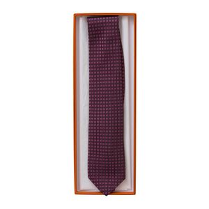 A tie by Hermes, styled with repeated pink H design on purple&hellip;