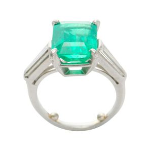 A Colombian emerald and diamond ring, featuring an emerald cut…