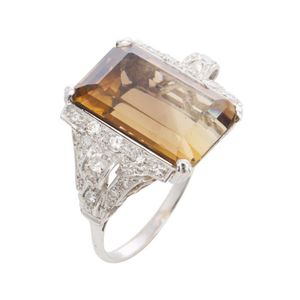 A smokey quartz and diamond ring, featuring an emerald cut…