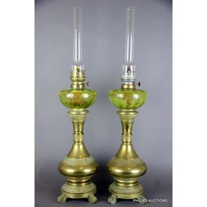 A pair of bronze and green glass banquet lamps, 19th century,…
