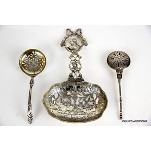 Three silver items a small sifter spoon, a miniature warming…