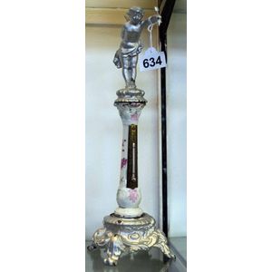 A Continental porcelain figural thermometer, on cast iron base.…