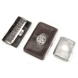 Two Victorian leather cases and a sterling silver case, the…