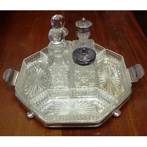 Vintage cut glass and silver plate cruet set on a silver silver…