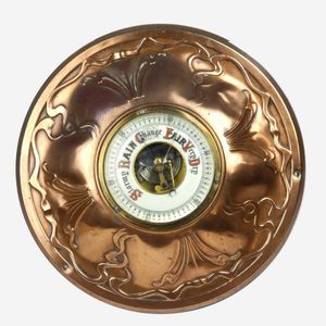 An Art Nouveau copper framed aneroid barometer, diameter 34 cm.…