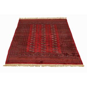 Afghan Bokhara rug, knotted wool rug featuring an open field of…
