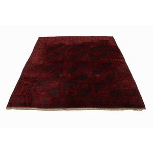 Afghan Bokhara rug, knotted wool rug featuring an open field of…