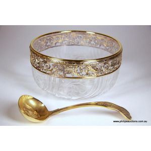 A glass and .950 silver rimmed bowl and a gilded ladle, 20th…