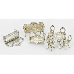 A sterling silver furniture doll set, comprising four chairs, a…