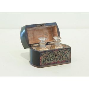 A hinged tortoise shell and brass inlaid box, opening to reveal…
