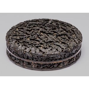An elaborately carved tortoiseshell lidded box, diameter 11 cm